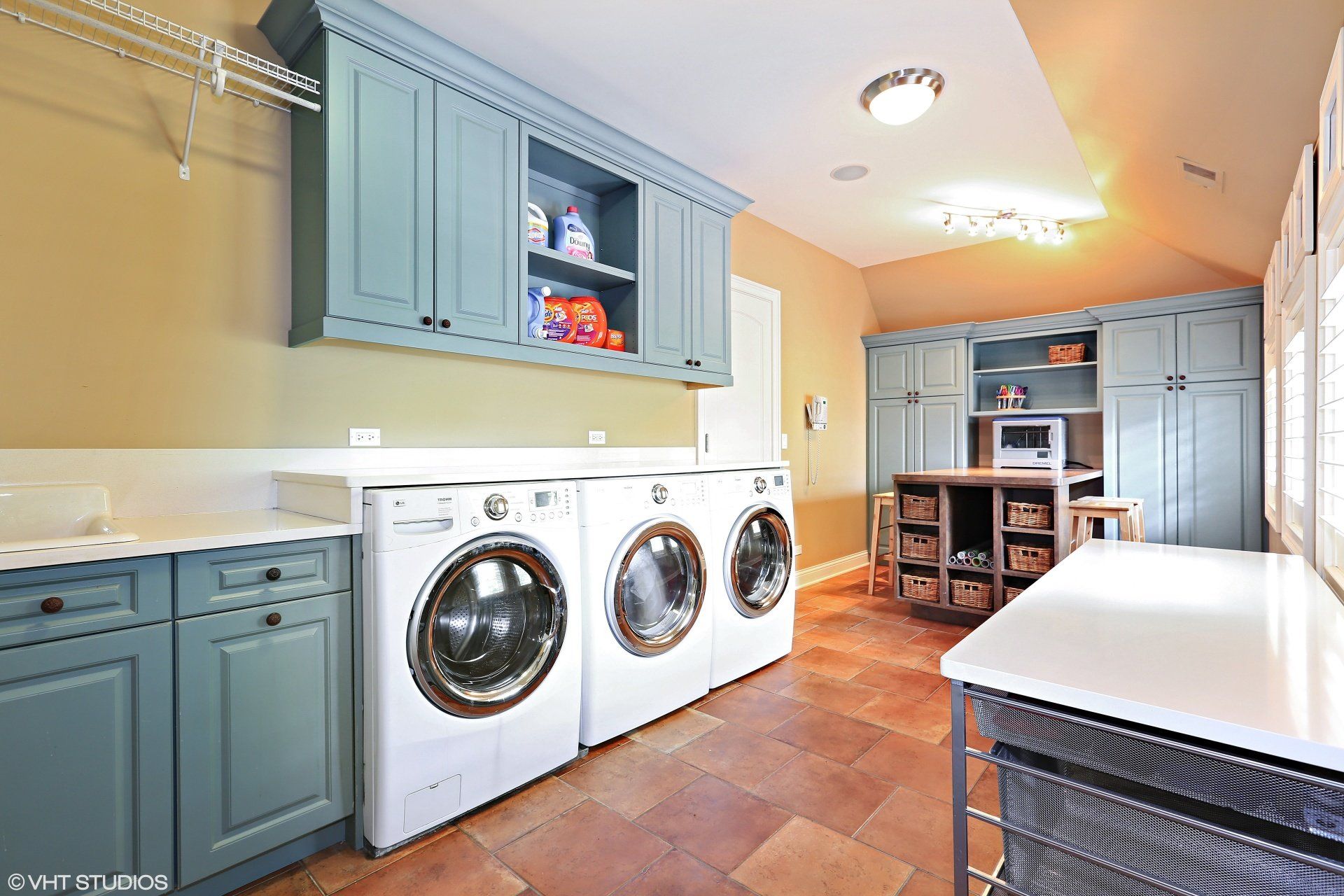 A laundry room with two washers and two dryers.