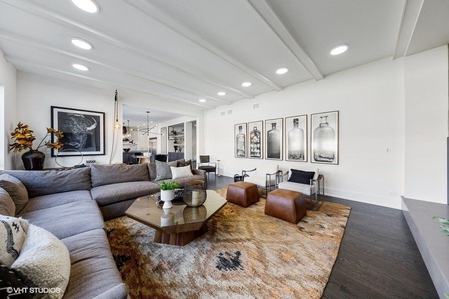 A living room with a large sectional couch and a coffee table.