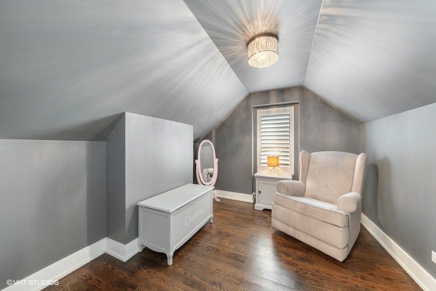 There is a chair and a mirror in the room.