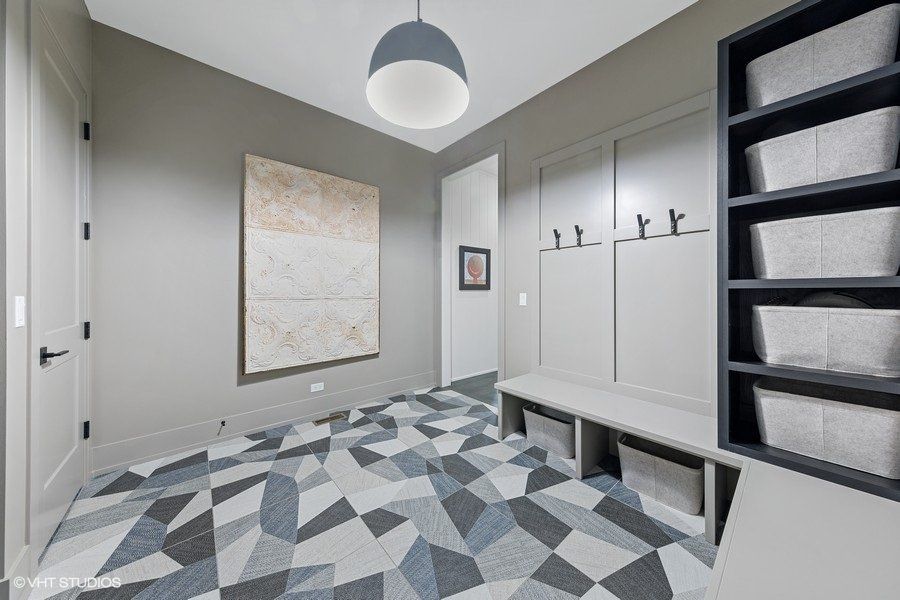 A room with a bench and a painting on the wall.