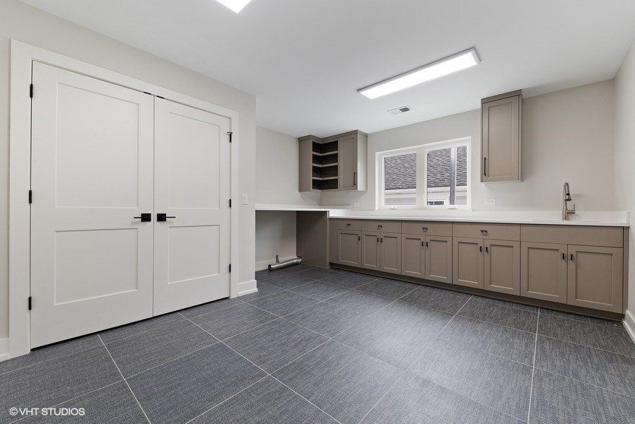 A kitchen with a lot of cabinets and a sink.