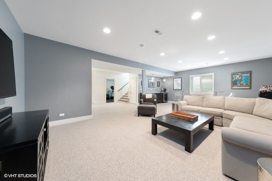 A living room with a couch , coffee table , and television.