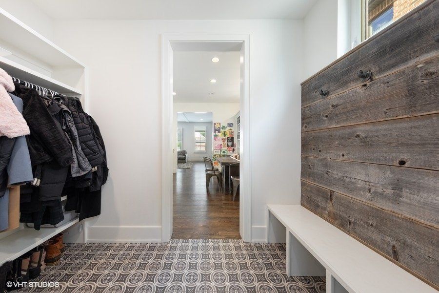 A hallway with a wooden wall and a bench.