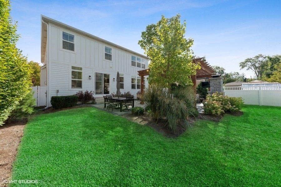 A large white house with a large lawn in front of it.