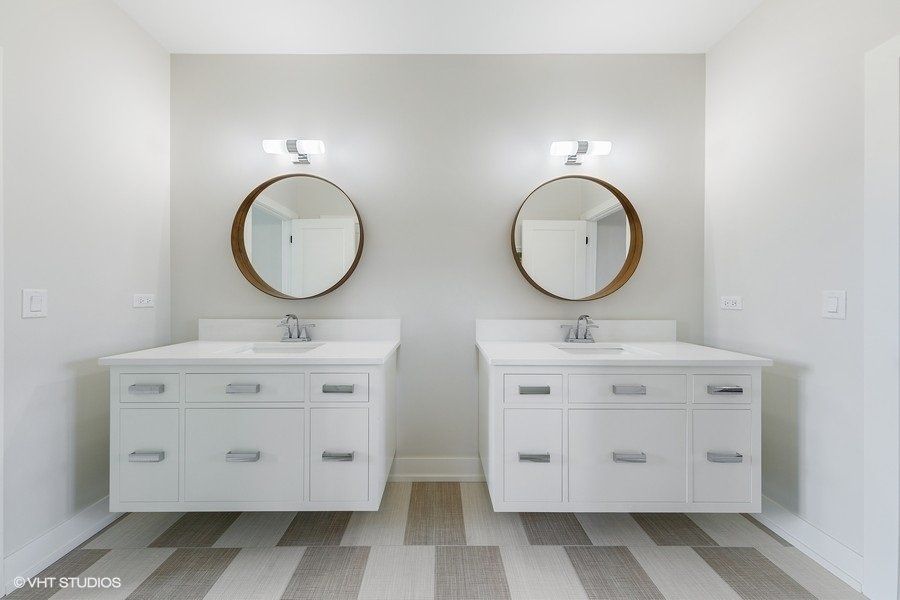 A bathroom with two sinks and two mirrors