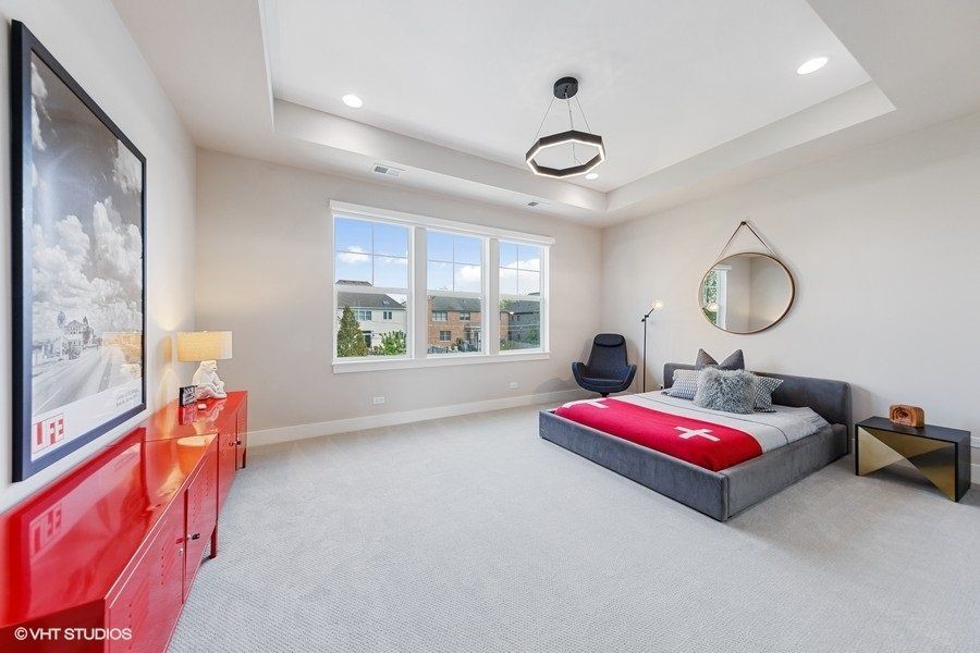 A bedroom with a large bed and a large window