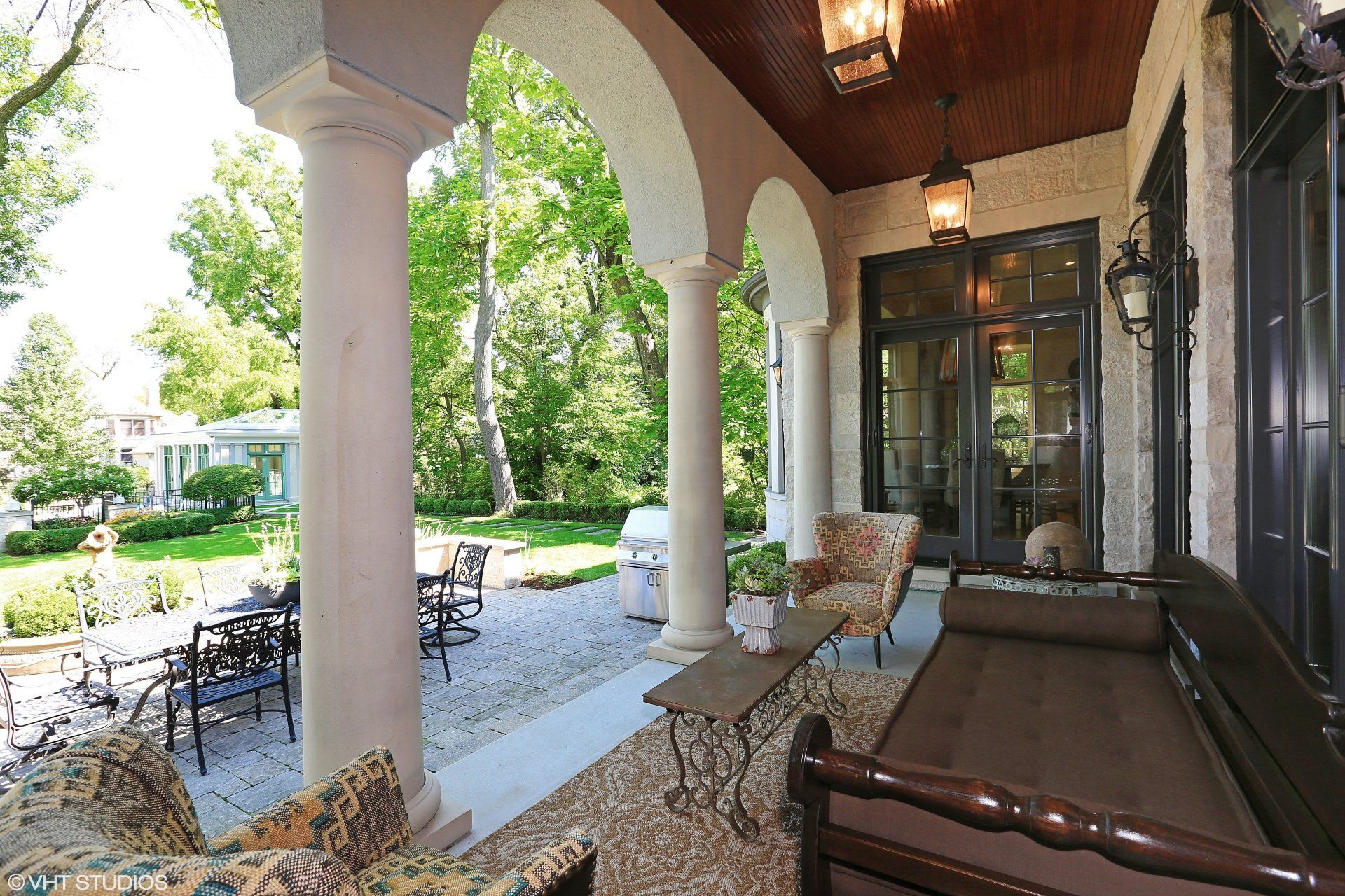 A porch with a couch and chairs on it