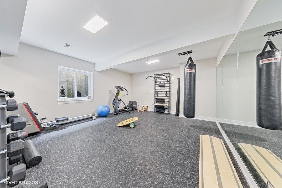 A gym with a lot of equipment and a mirror.