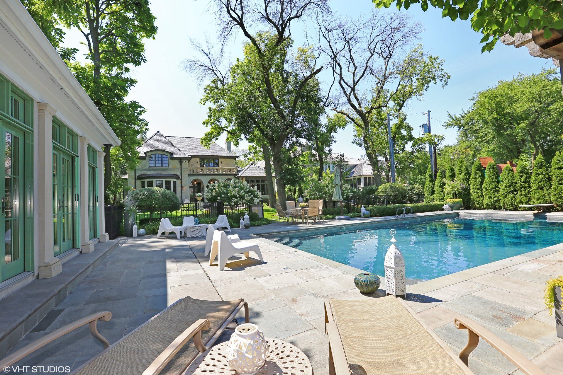 A large swimming pool in the backyard of a house