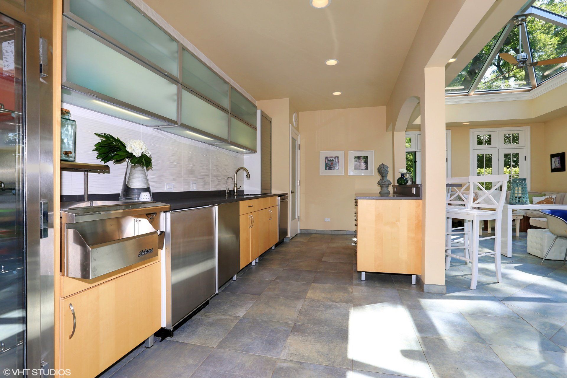 A kitchen with stainless steel appliances and wooden cabinets