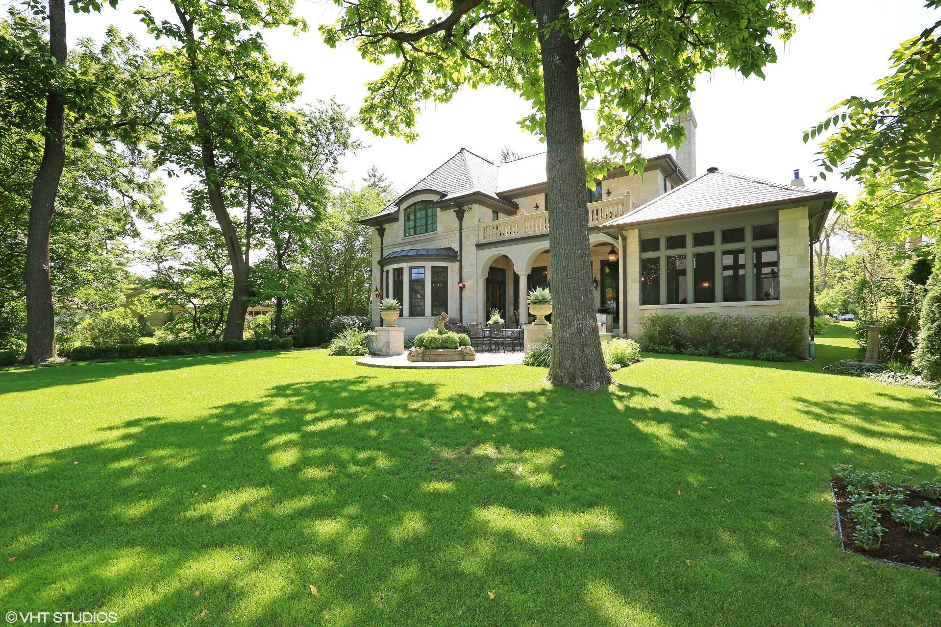 A large house with a lush green lawn in front of it
