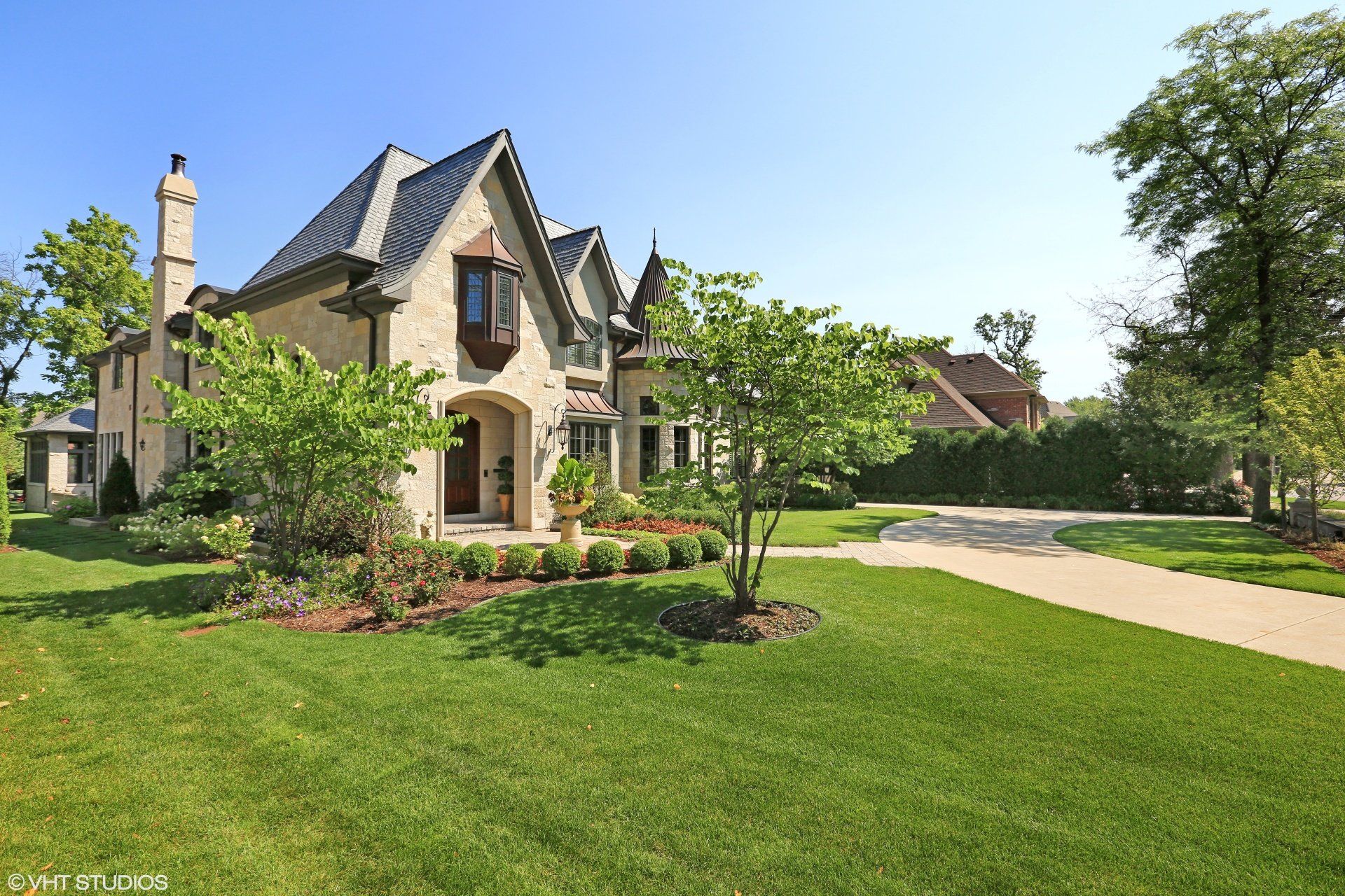 A large house with a lush green lawn in front of it