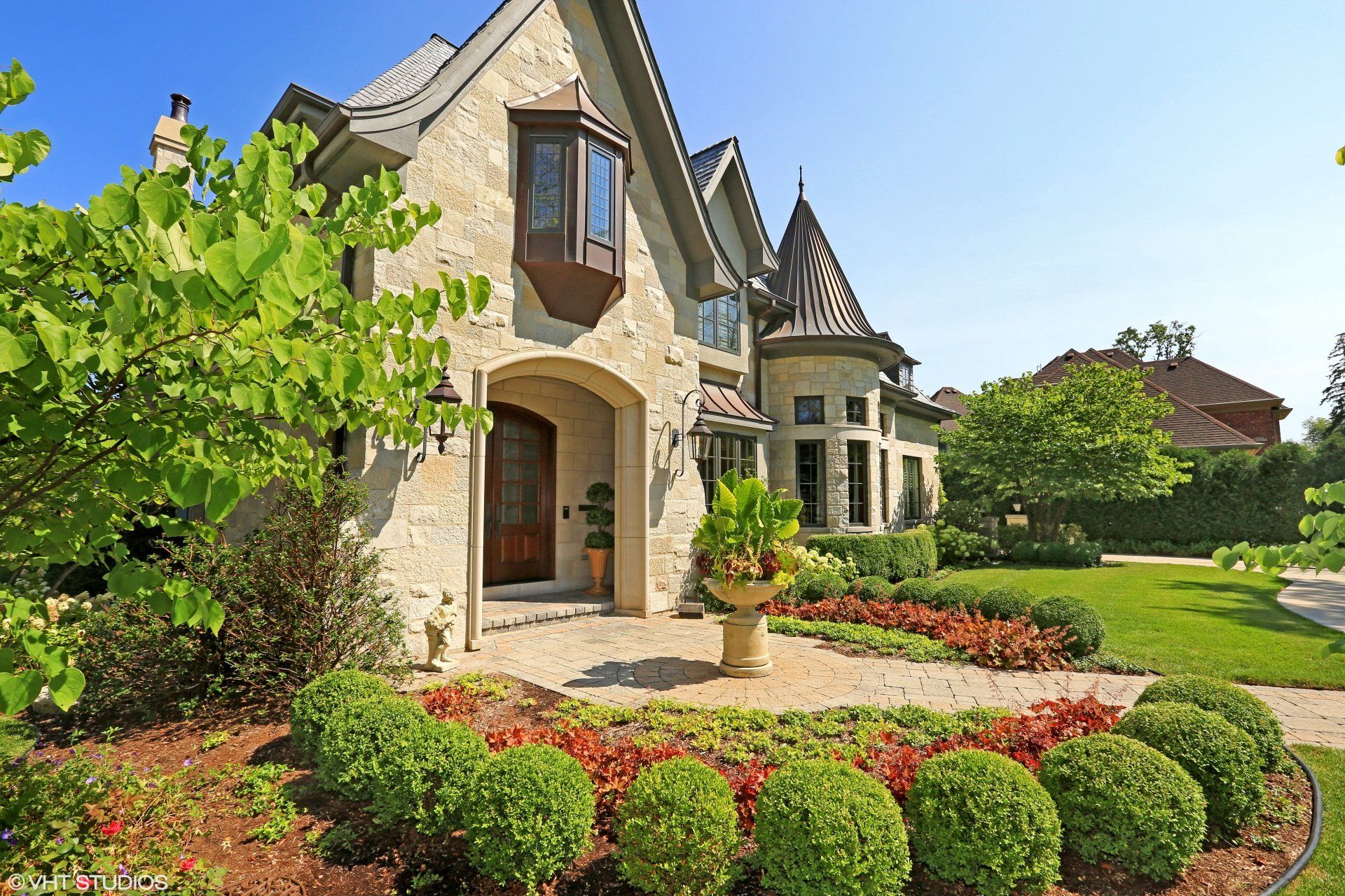 A large house with a lush green lawn in front of it