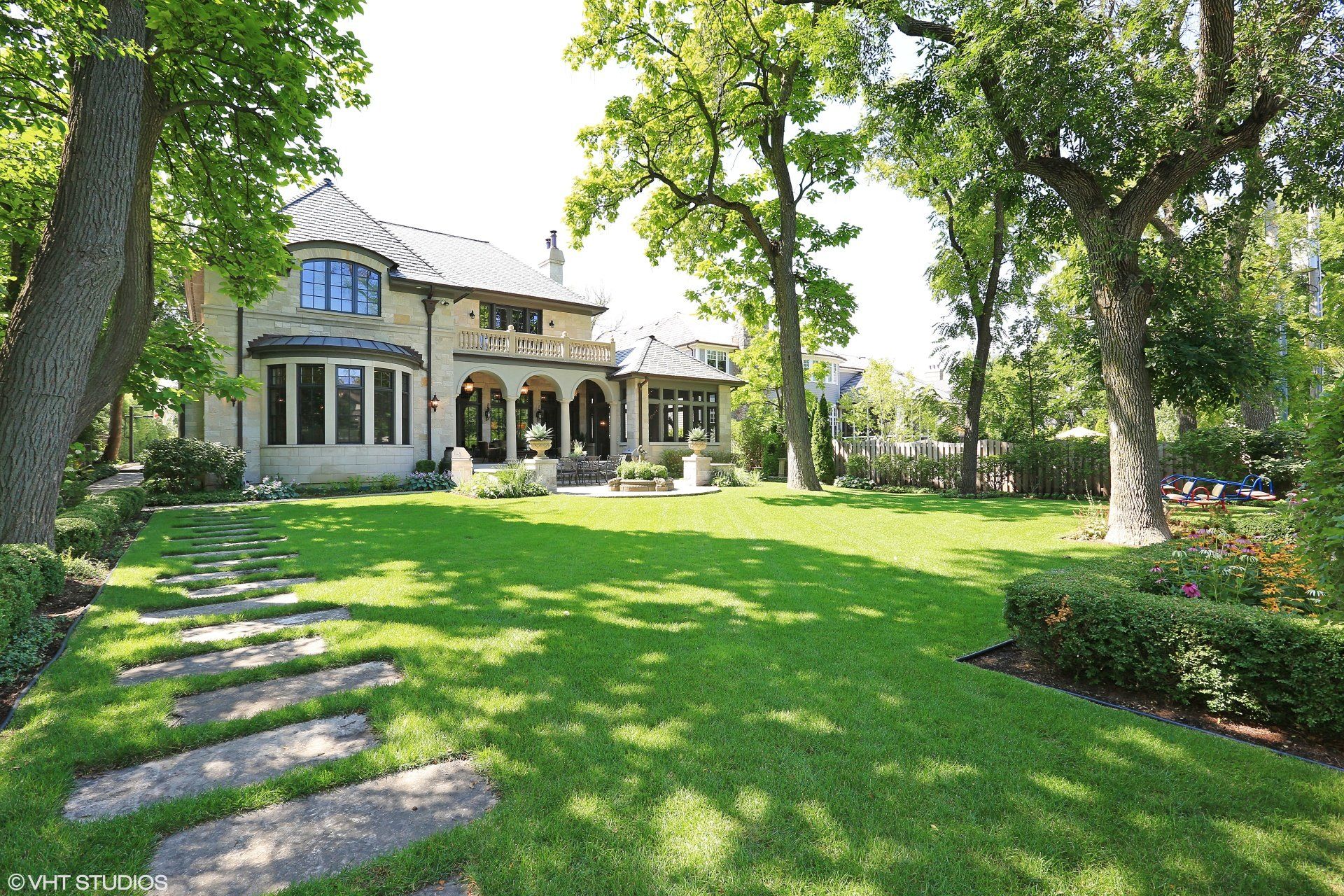 A large house with a lush green lawn in front of it