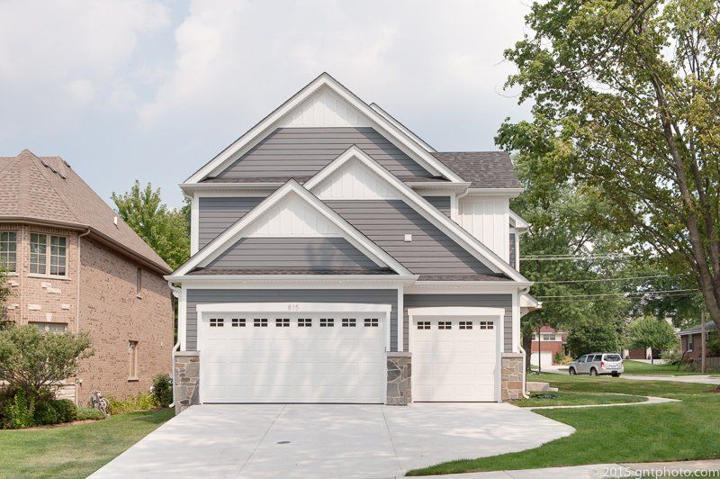 A house with two garage doors and a driveway