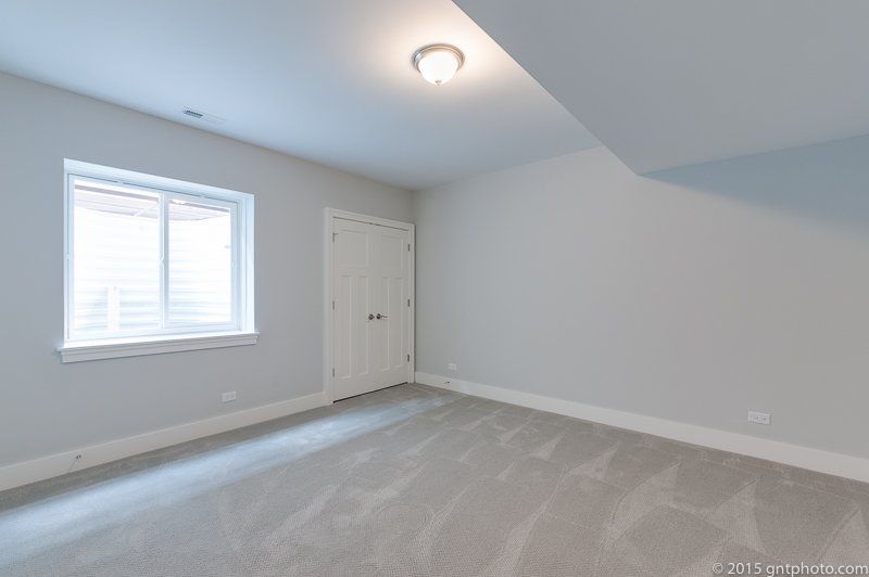 An empty room with a window and a door.