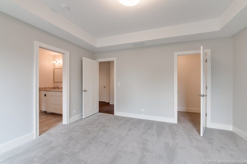 An empty bedroom with a bathroom and a closet