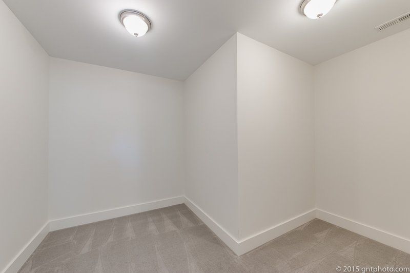 An empty room with white walls and a light on the ceiling.
