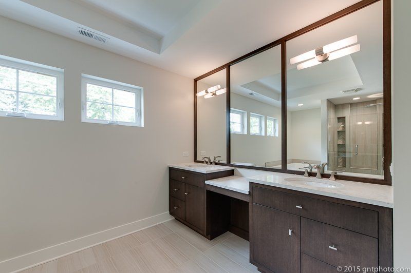 A bathroom with two sinks and two mirrors.
