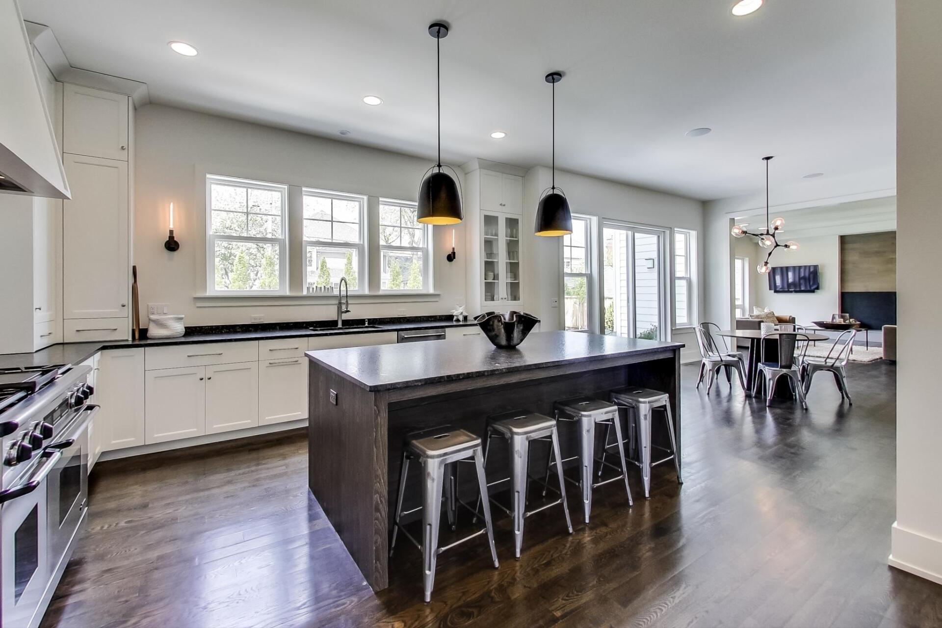 A kitchen with a large island and stools