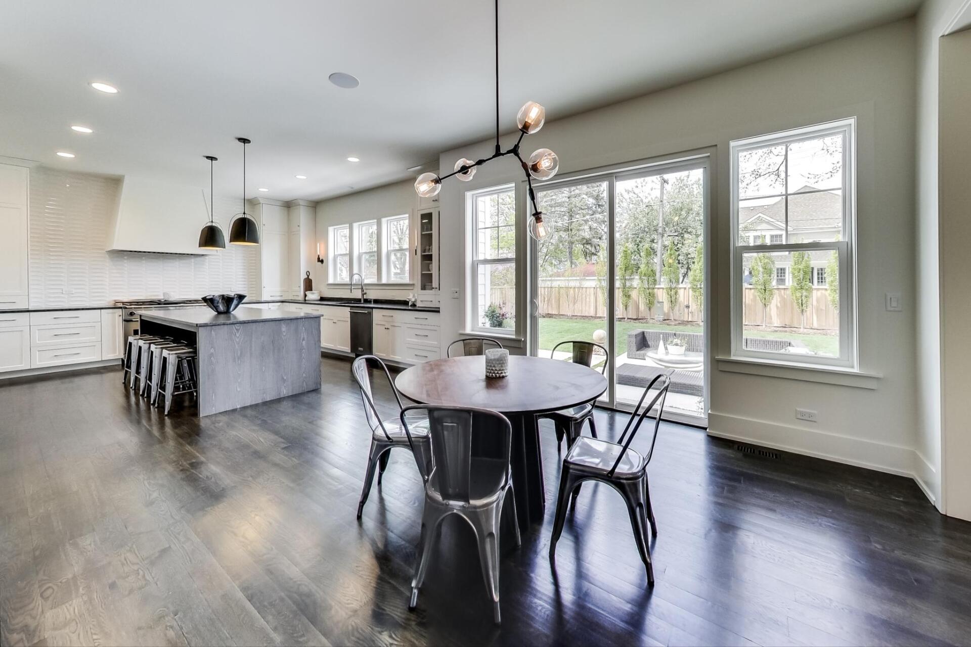 There is a dining table and chairs in the middle of the room.