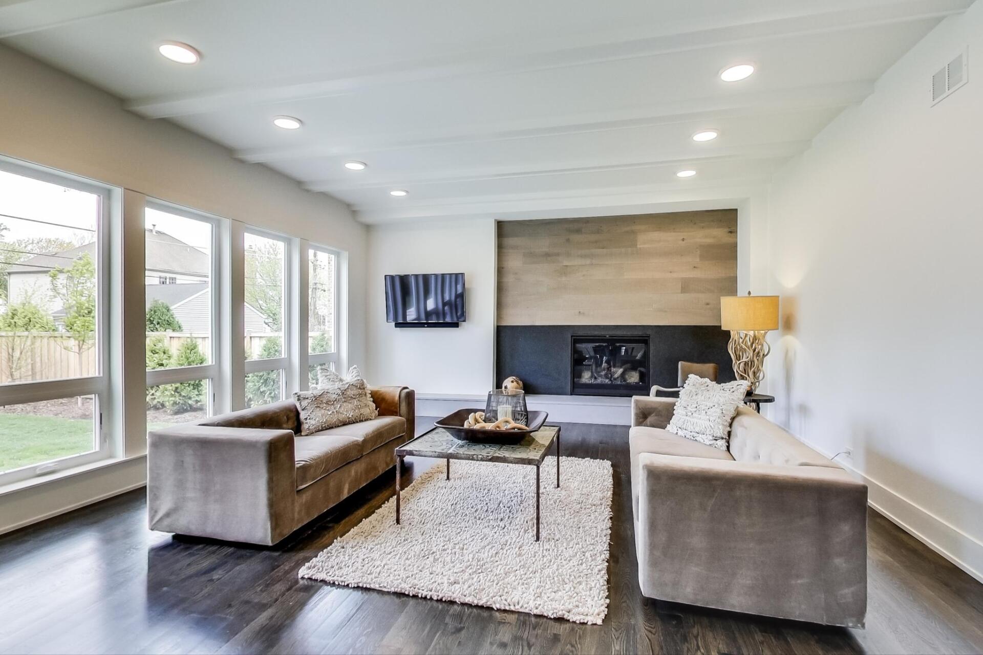 A living room with two couches , a coffee table , and a fireplace.