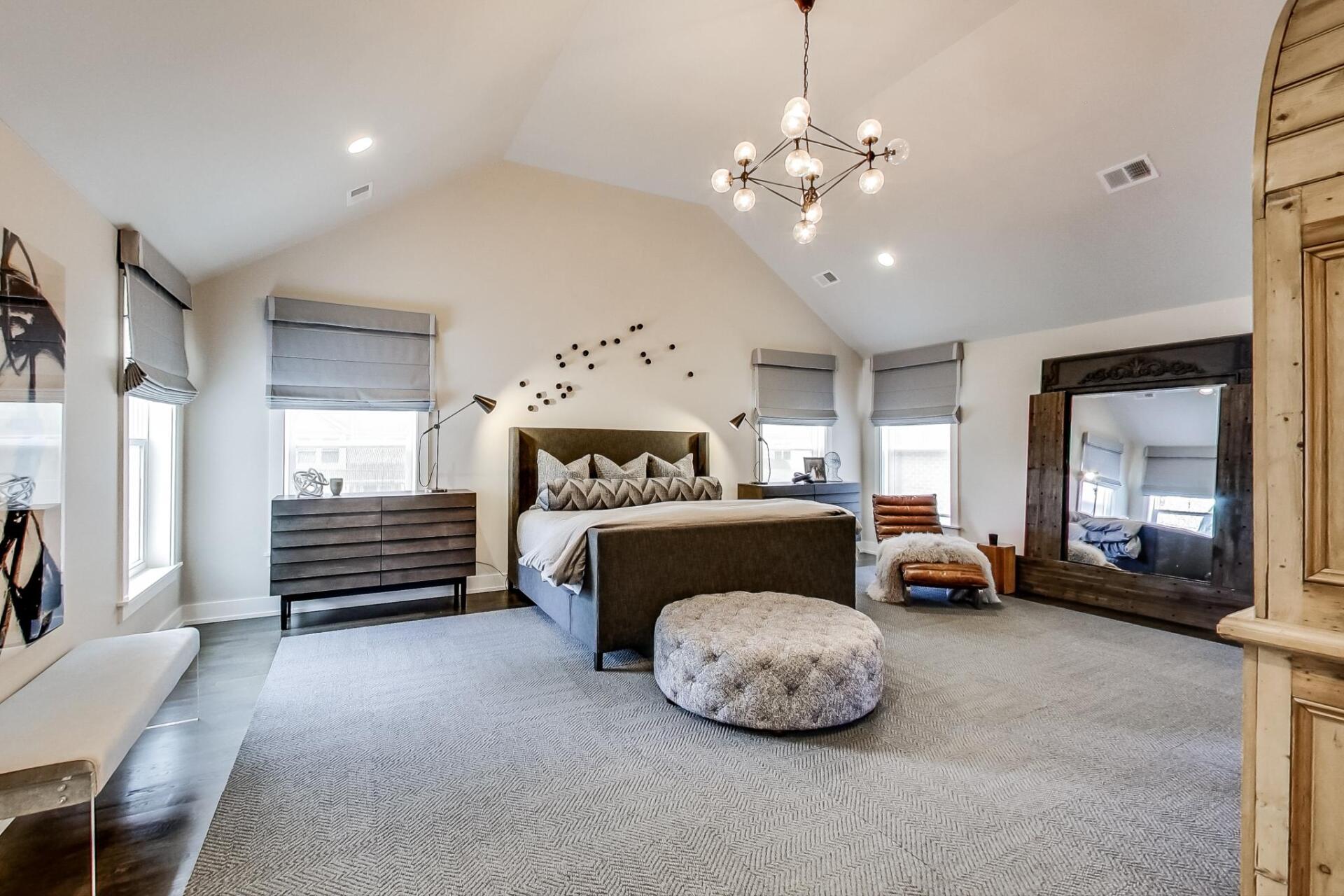 A large bedroom with a vaulted ceiling and a large bed.