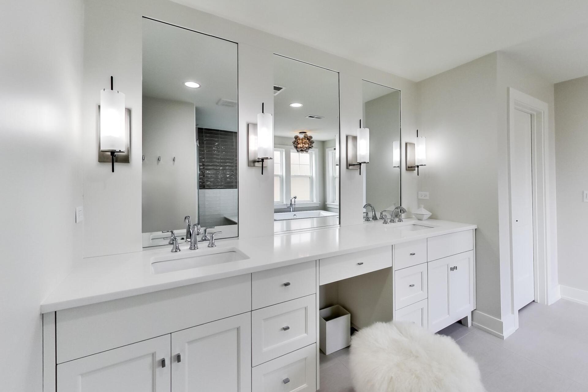A bathroom with two sinks and two mirrors.