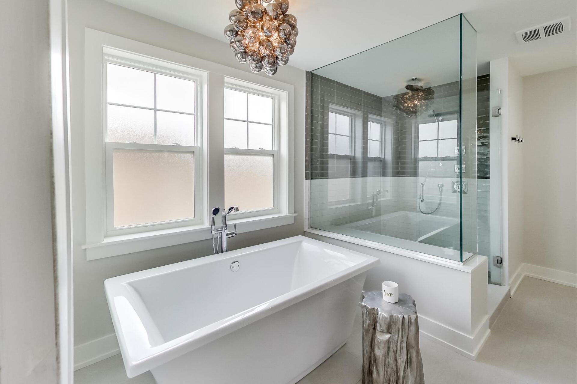 A bathroom with a bathtub and a walk in shower.