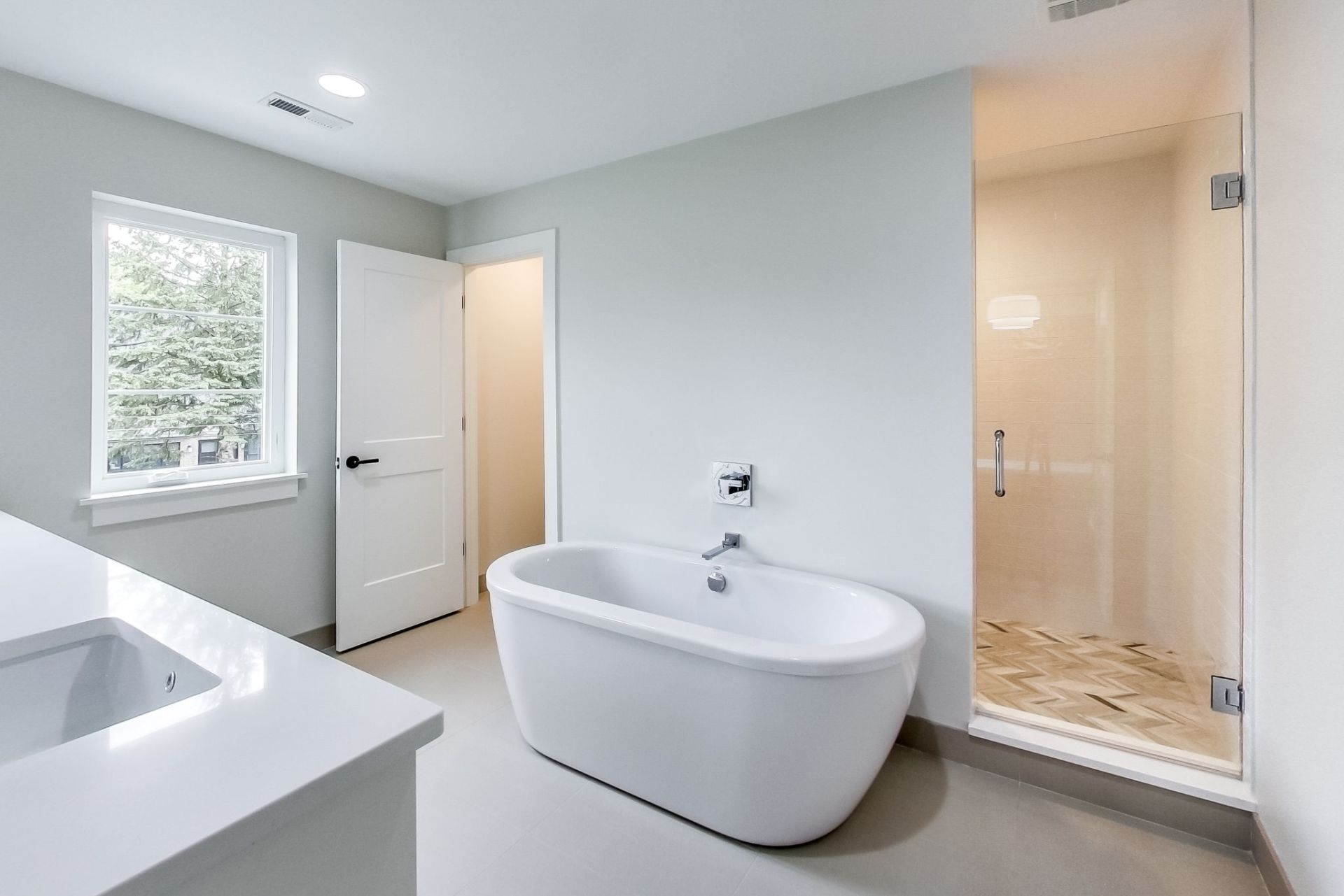 A bathroom with a bathtub , sink , and shower.