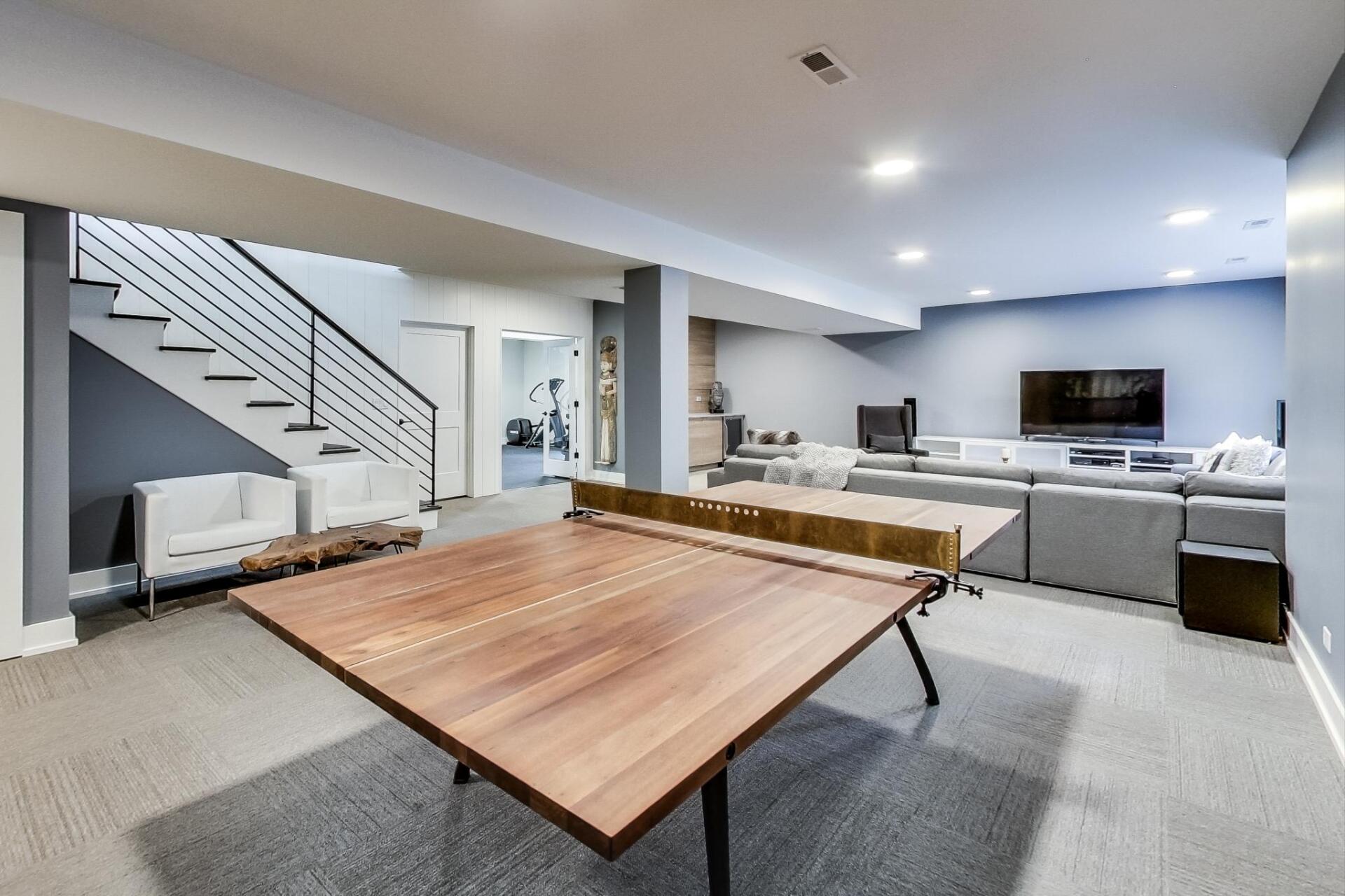 There is a ping pong table in the middle of the room.