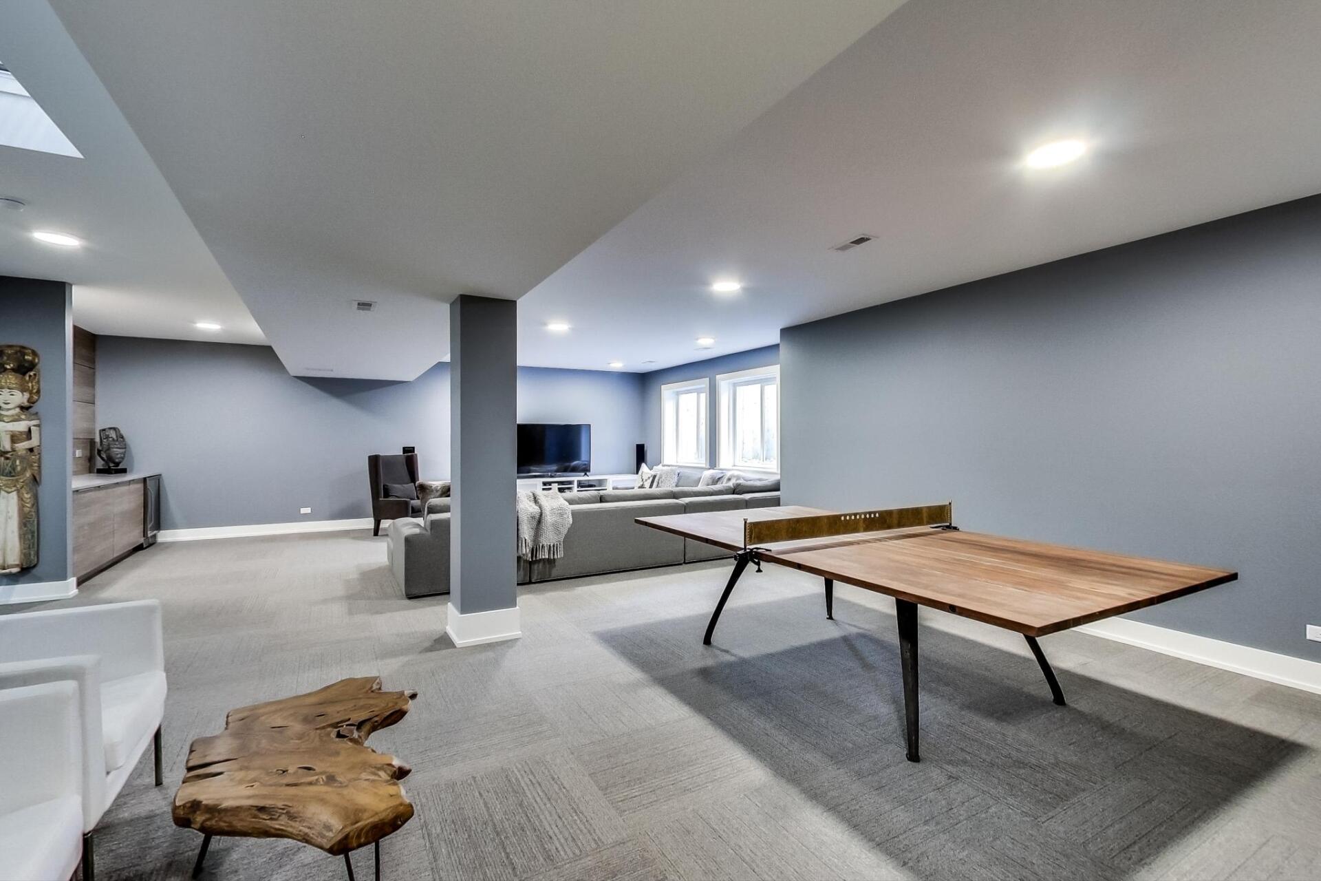 There is a ping pong table in the middle of the room.