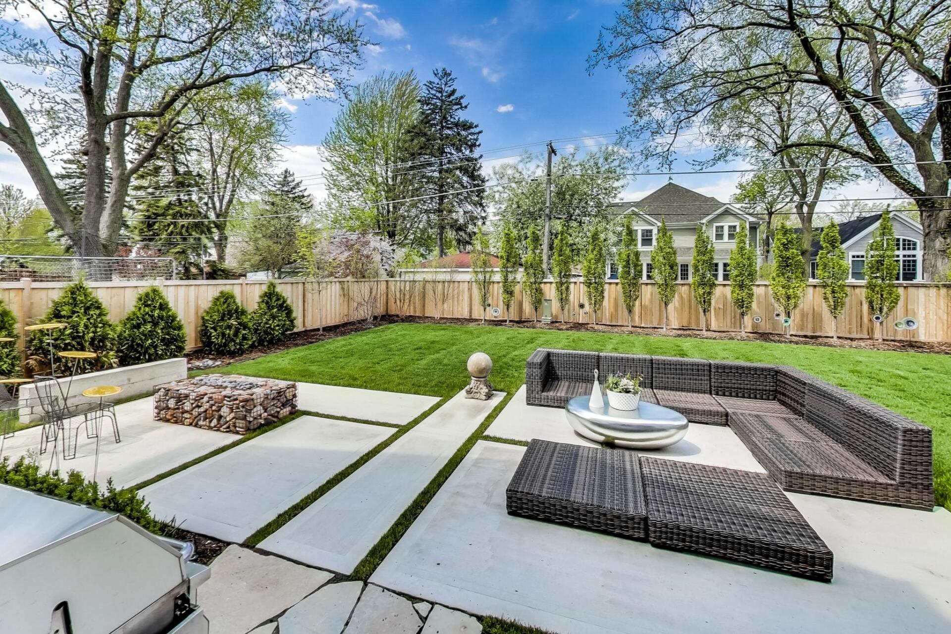 There is a fire pit in the middle of the backyard.