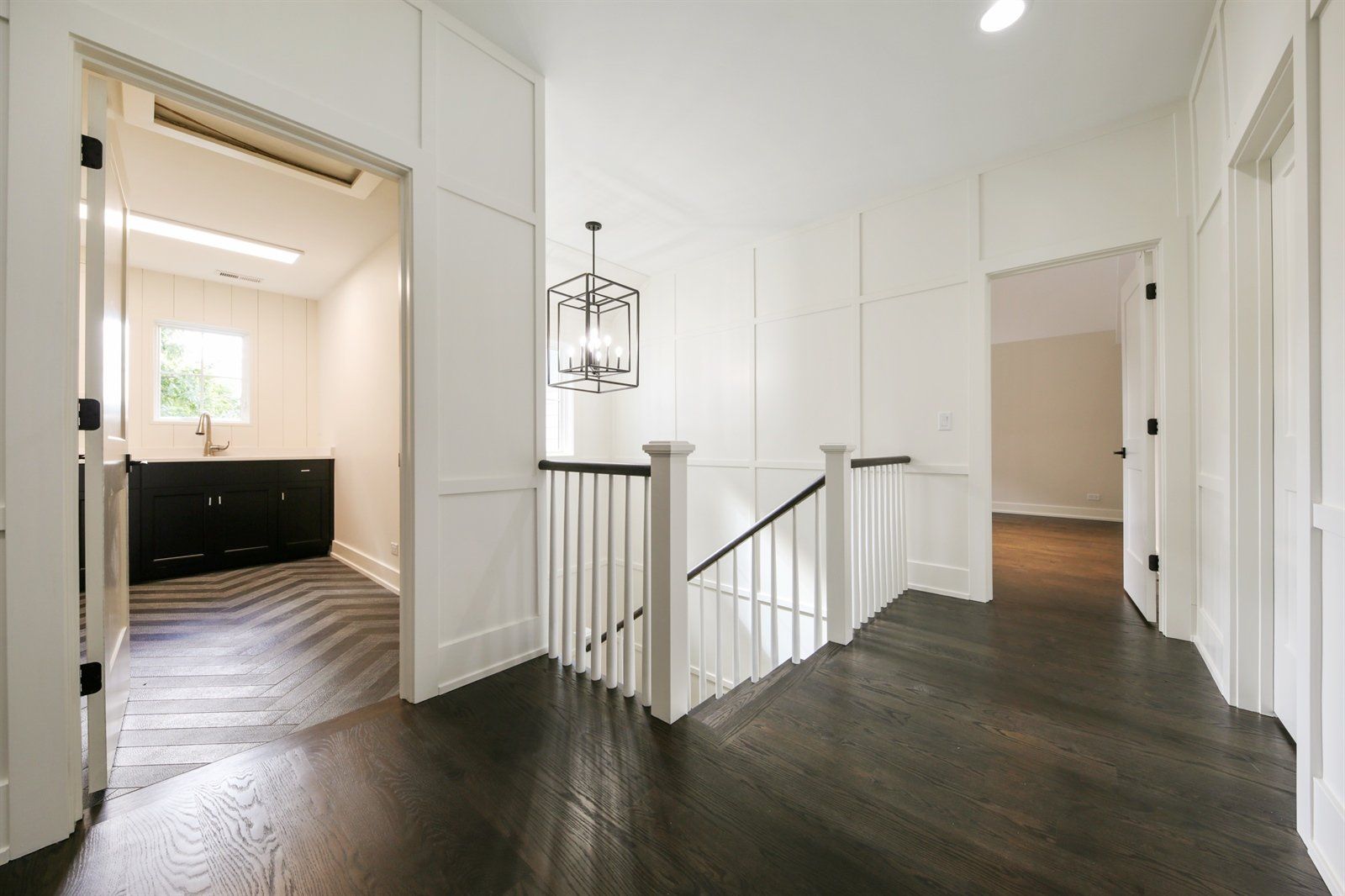 A hallway with a staircase leading up to the second floor of a house.