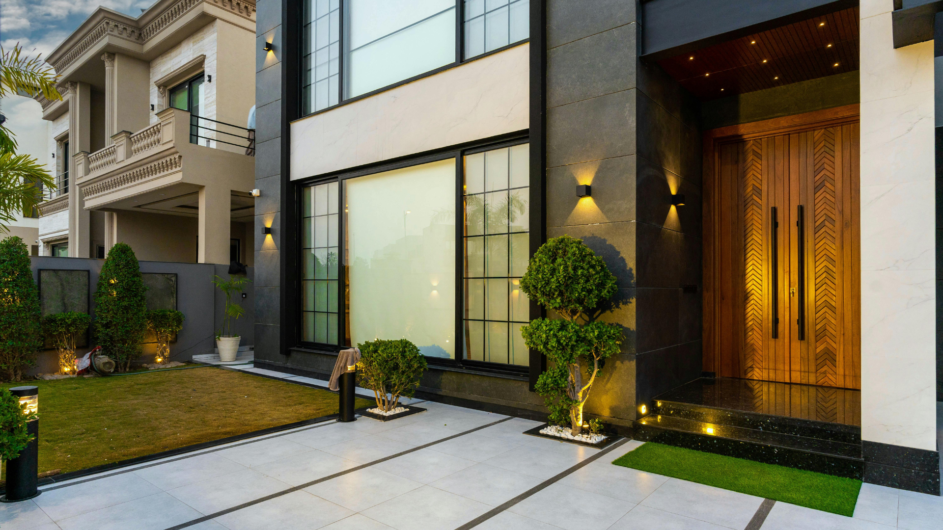A living room with a guitar and a television on the wall.