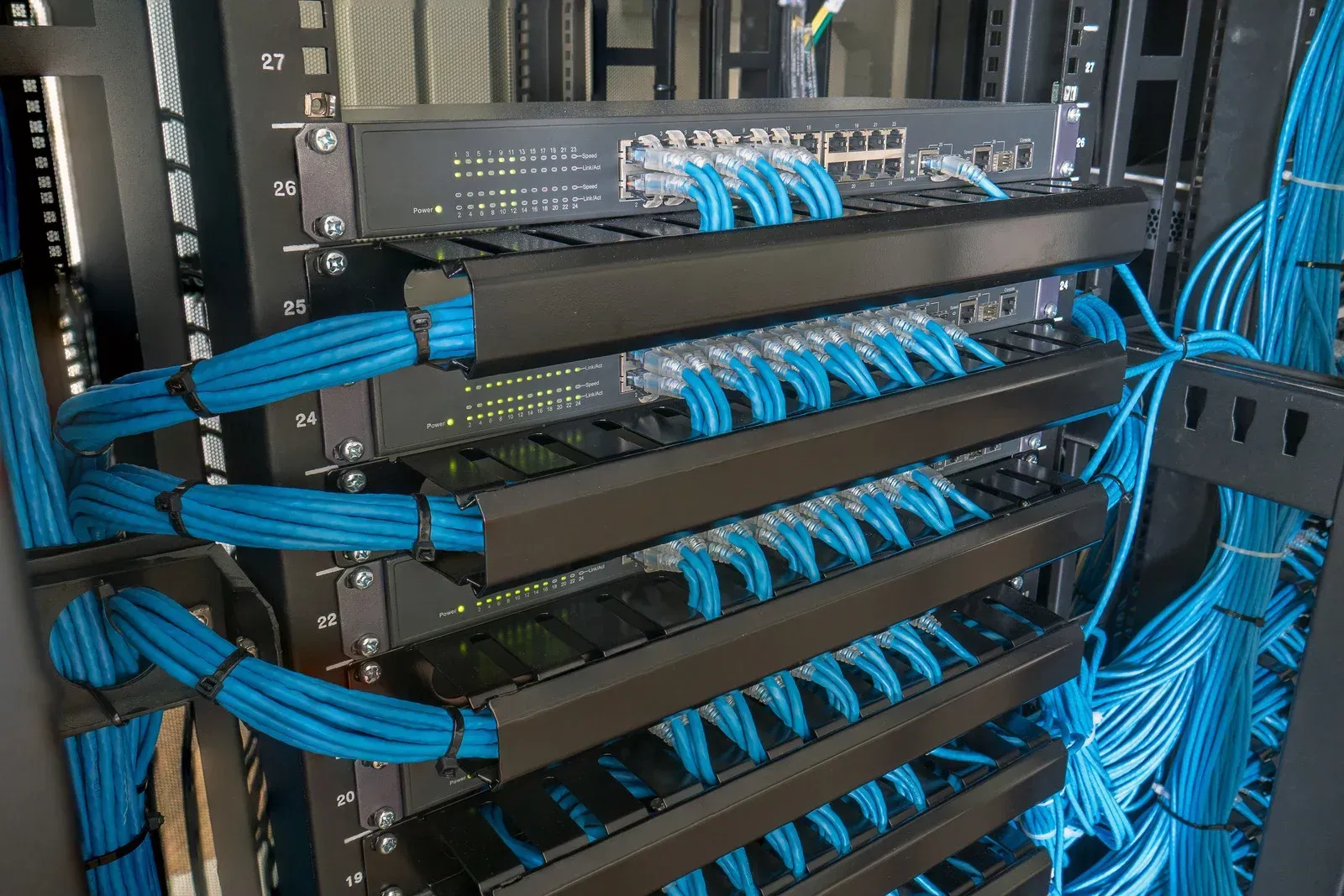 A server rack filled with lots of blue wires.