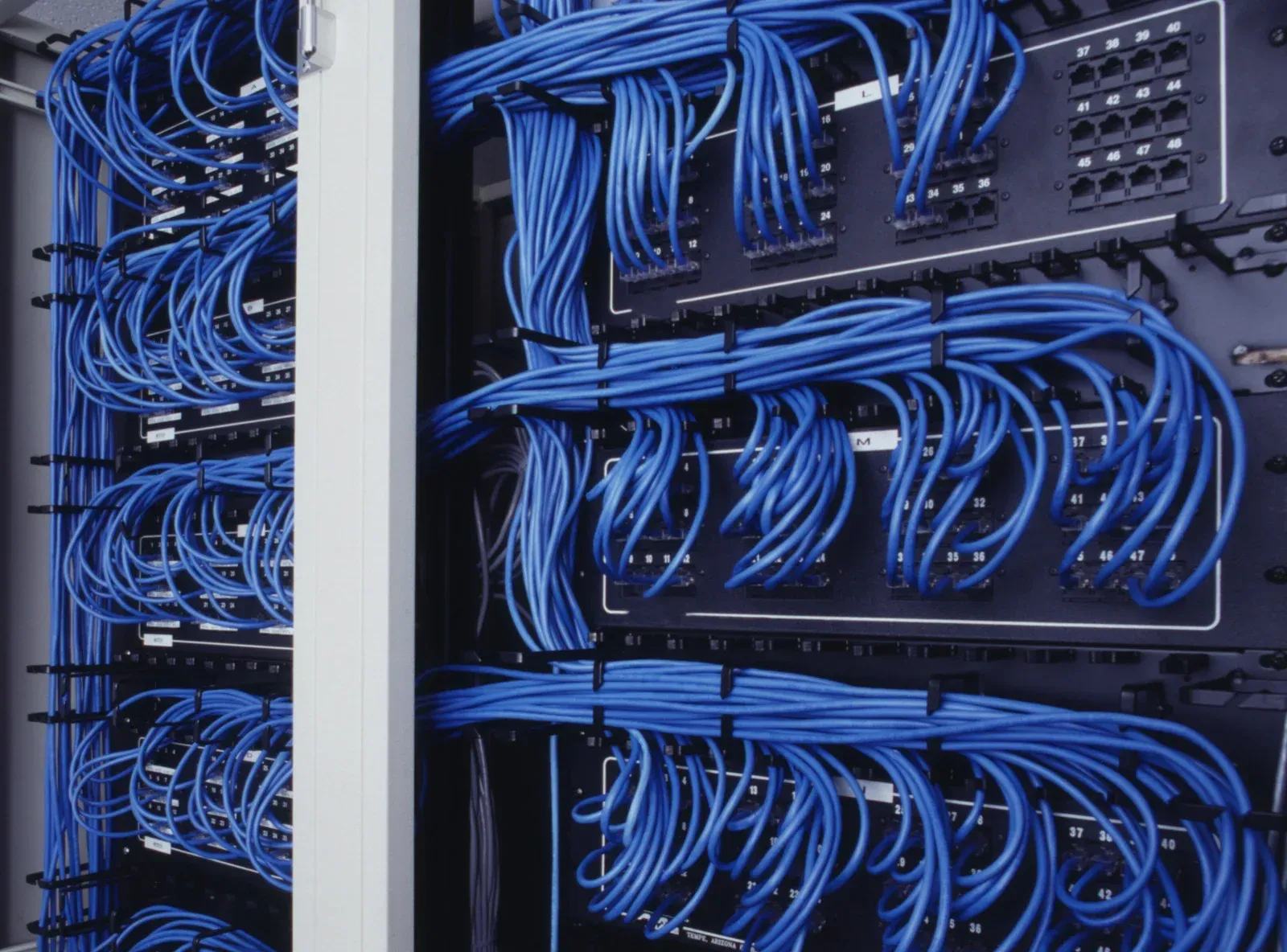 A bunch of blue wires are connected to a server