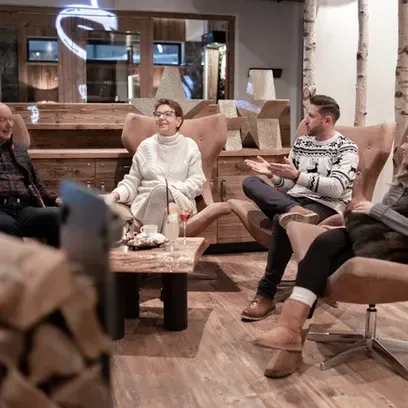 A Group Of People Are Sitting Around A Table In A Living Room - Phoenix, AZ - Infinite Healing and W