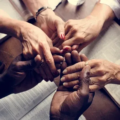 A Group Of People Are Putting Their Hands Together In A Circle - Phoenix, AZ - Infinite Healing and 