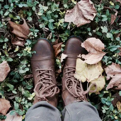 A Person Wearing Brown Boots Is Standing In A Pile Of Leaves - Phoenix, AZ - Infinite Healing and We