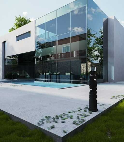 A large glass building with a swimming pool in front of it