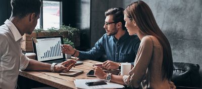 Desk with calculator, paperwork, keyboard, coffee, and office supplies.