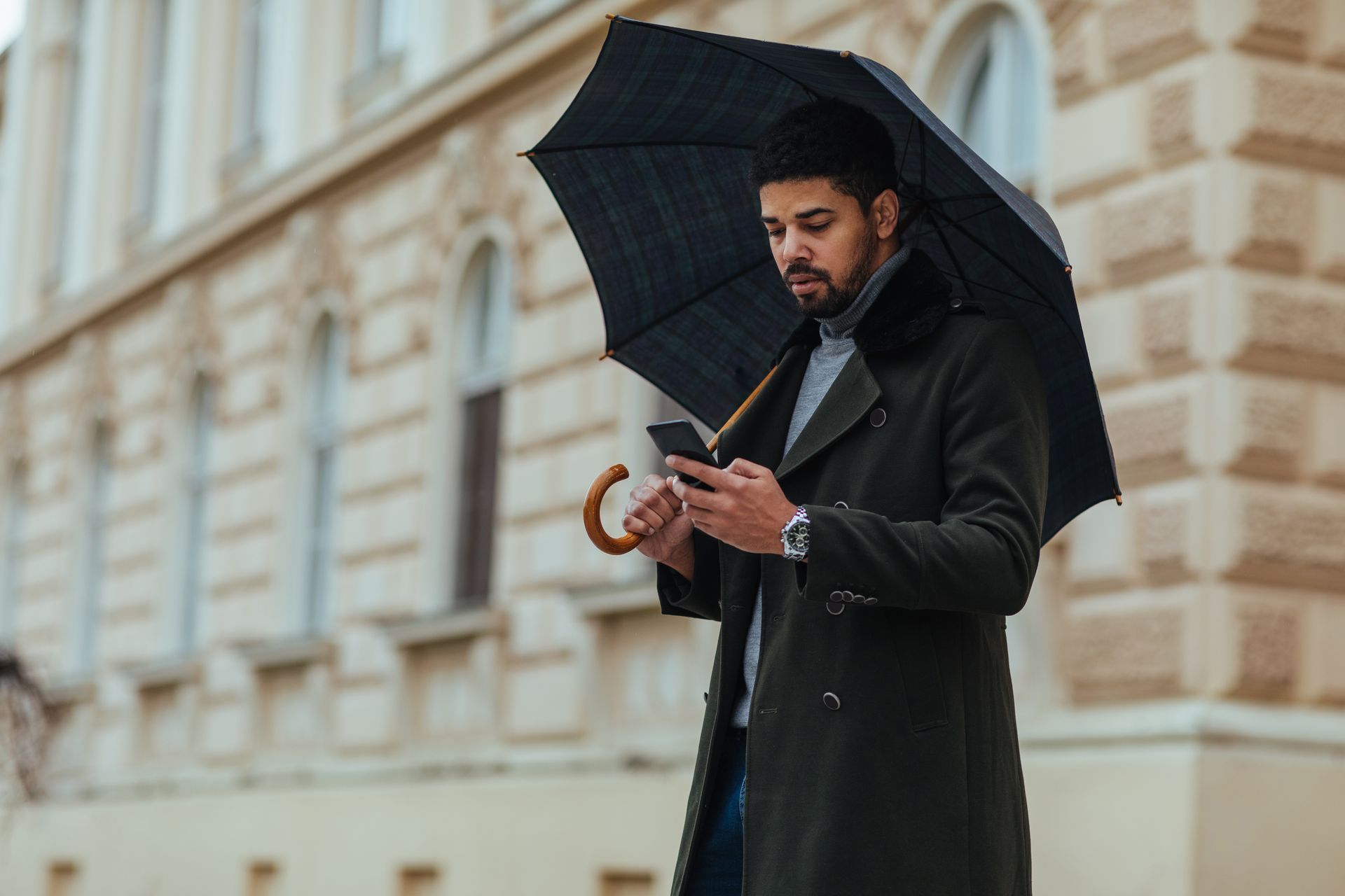 Two women reviewing documents, one using a calculator, in a bright office setting.
