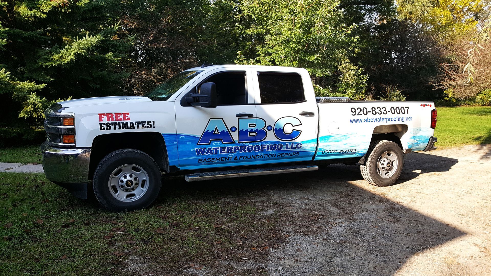 White pickup truck with company logo 
