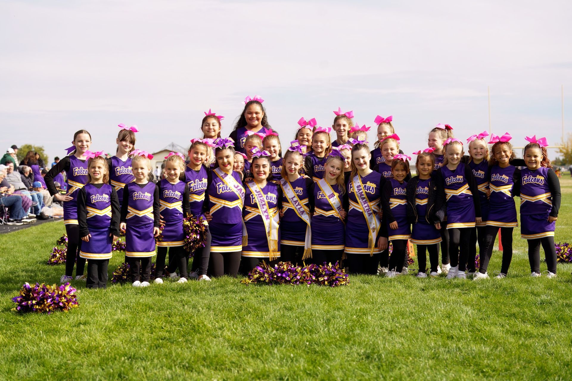 Red, white, and blue pom-poms held high by cheerleaders during a performance.
