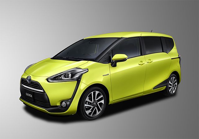 Yellow Toyota Sienta minivan, front view, set against a gray backdrop.