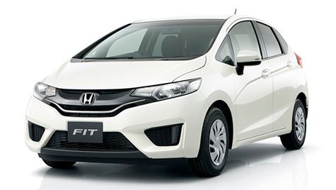 White Honda Fit hatchback car.