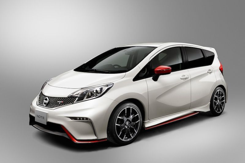 White Nissan Note hatchback with red accents on a gray background.