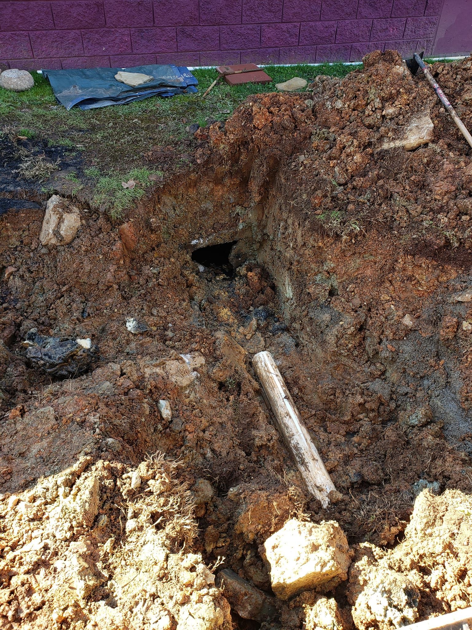 A pile of dirt with a shovel in the middle of it.