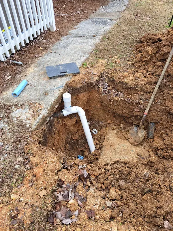 A pipe is being installed in a hole in the ground.